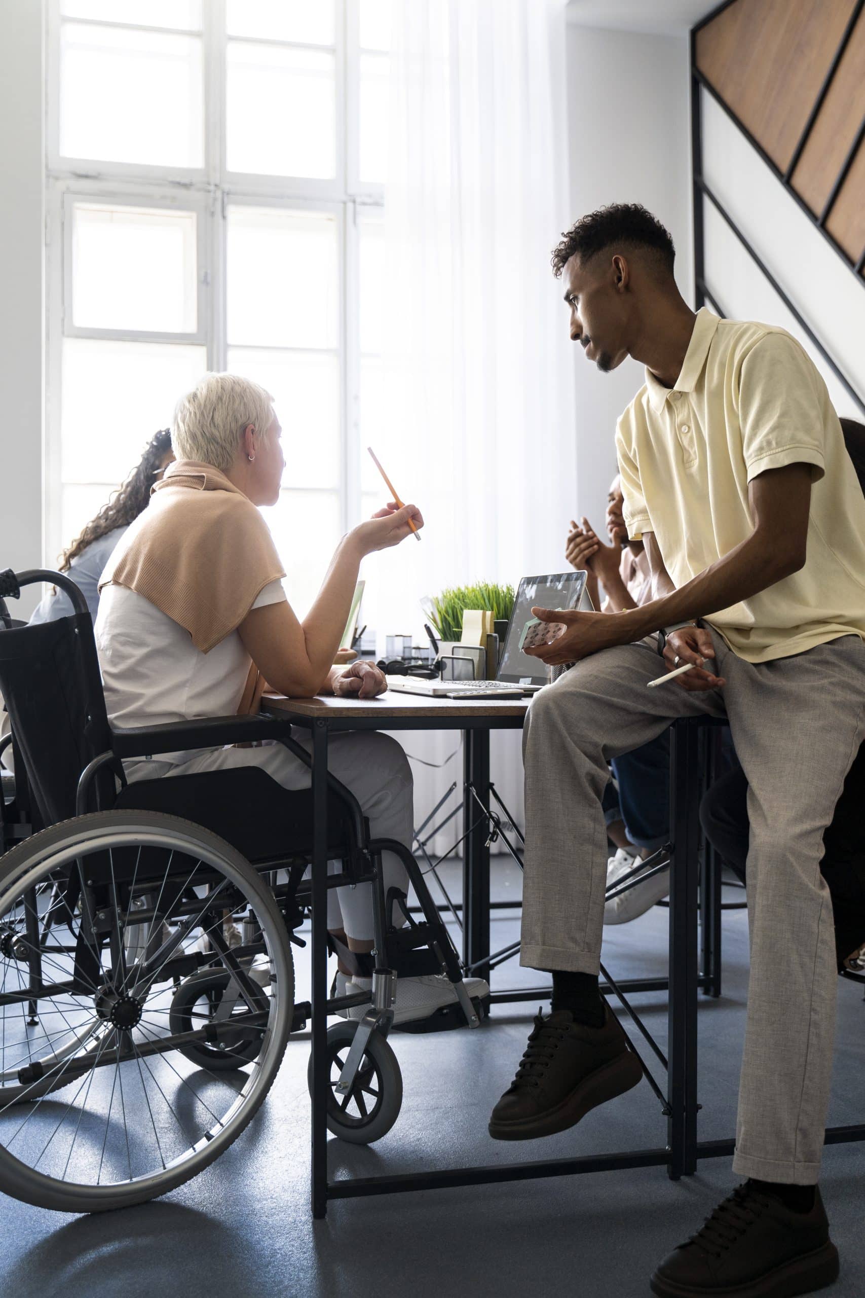 side-view-woman-wheelchair-work Culturally Sensitive Home Care