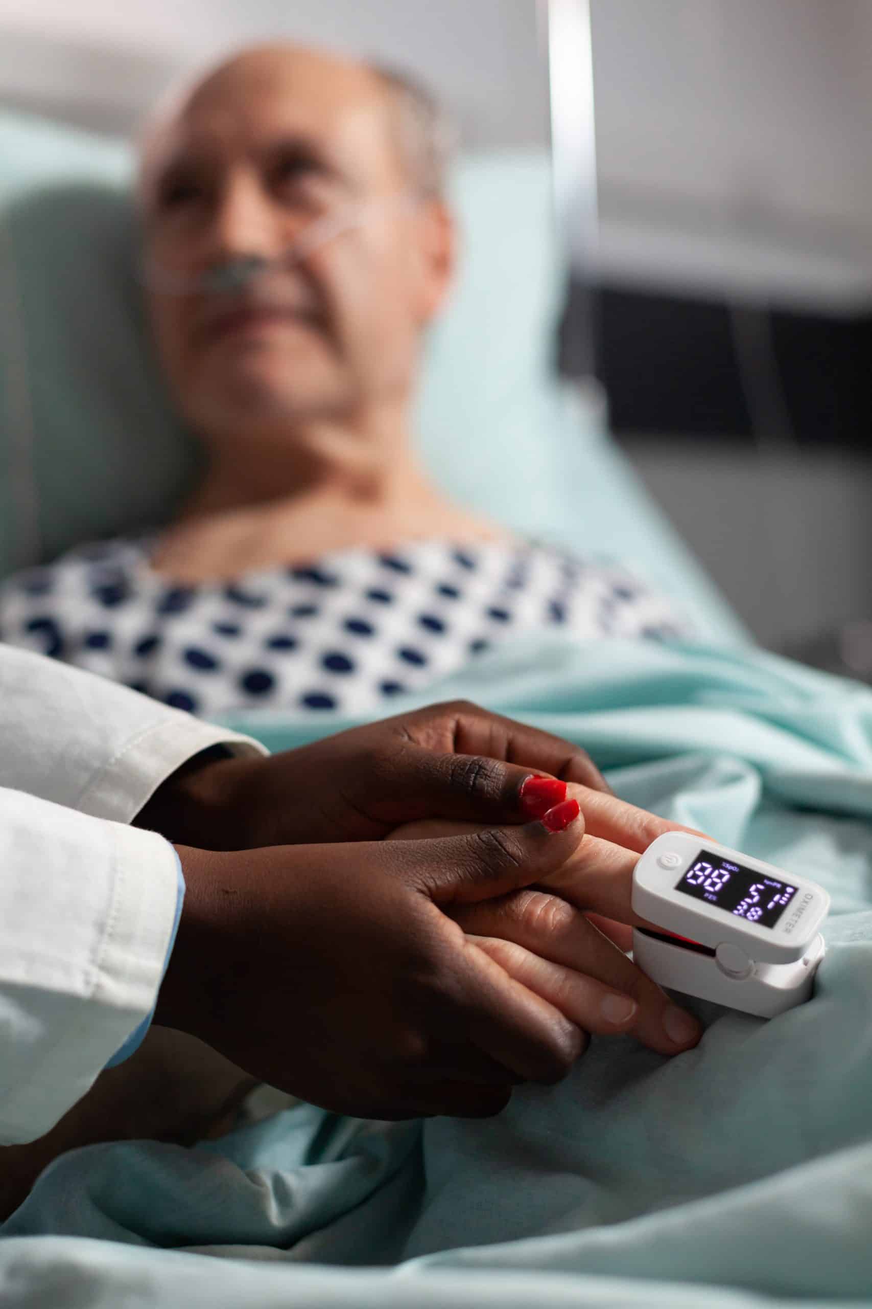 Caring friendly african american doctor holding senior patient hand Post-Surgical Care